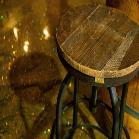 An image of a finished gold glitter epoxy resin floor in a bar.