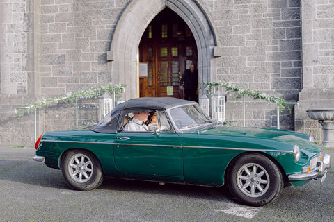 Vintage MG car arriving at the church