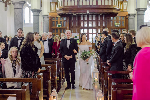 Father guides the bride on the Isle into her wedding ceremony