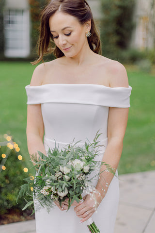 Elegant bride with stunning bridal bouquet of soft white winter flowers