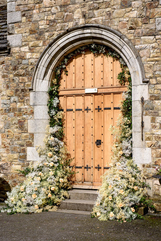 Floral arch at a Castle wedding entrance