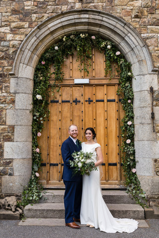 Bride and Groom in front of Irish Castle entrance at Waterford Castle