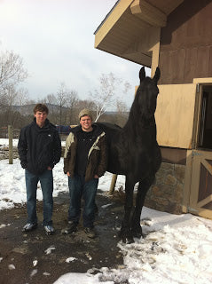 Trevor Young (center) and two friends at the Friesians Of Majesty farm.