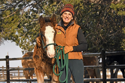 Julie Goodnight standing with a horse