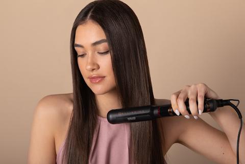 woman straightening her hair