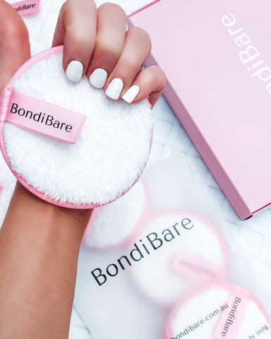 hand holding BondiBare luxe reusable makeup remover cleansing face puff