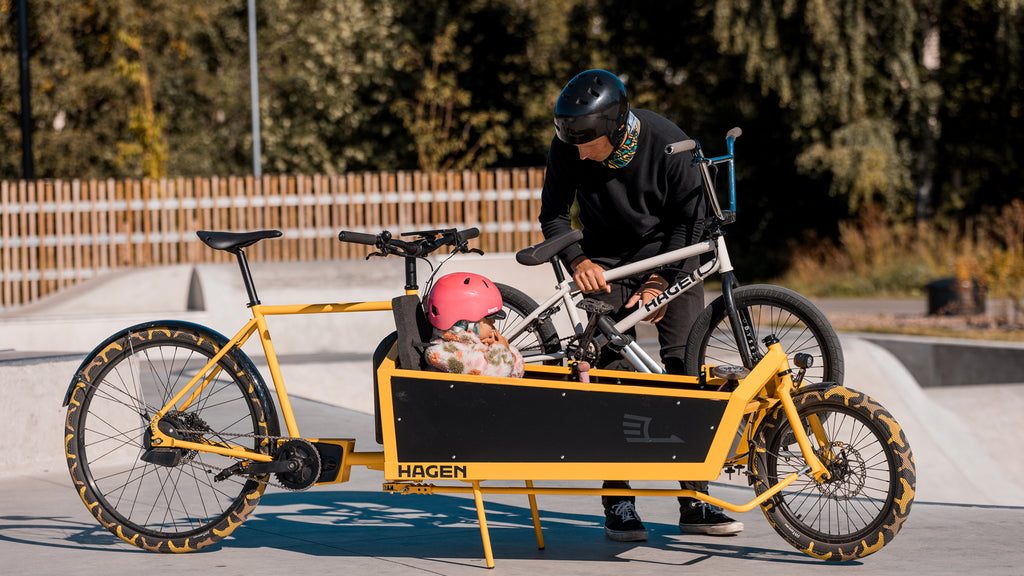 Hagen Bikes Founder Kaspar Peek dismounting his BMX bike from XL cargo bike