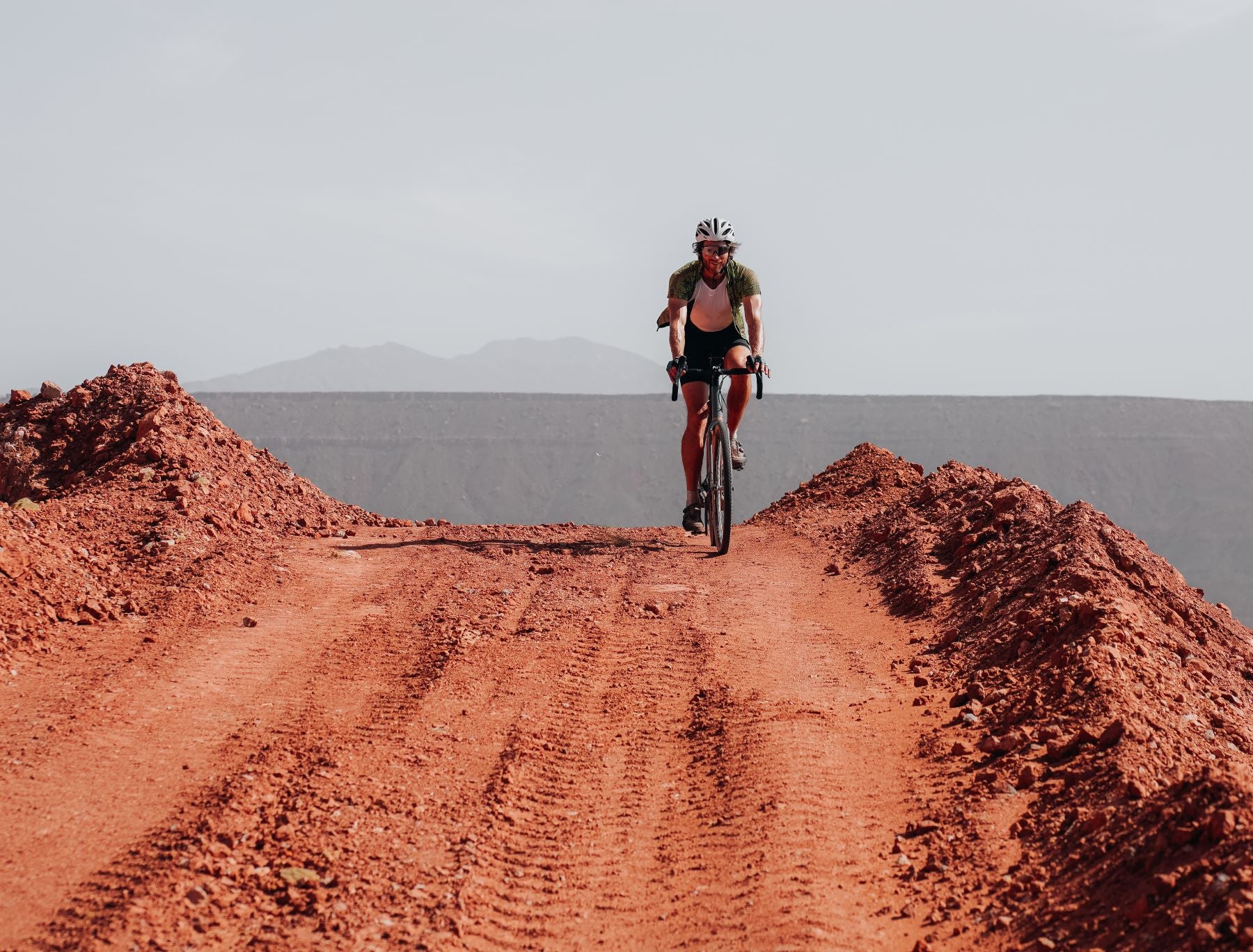 cyclist adjusting position on the bike 