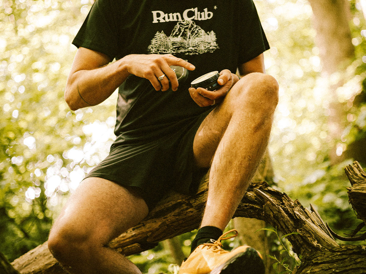 athlete using the Styrkr bodycare cream wearing a run club t-shirt