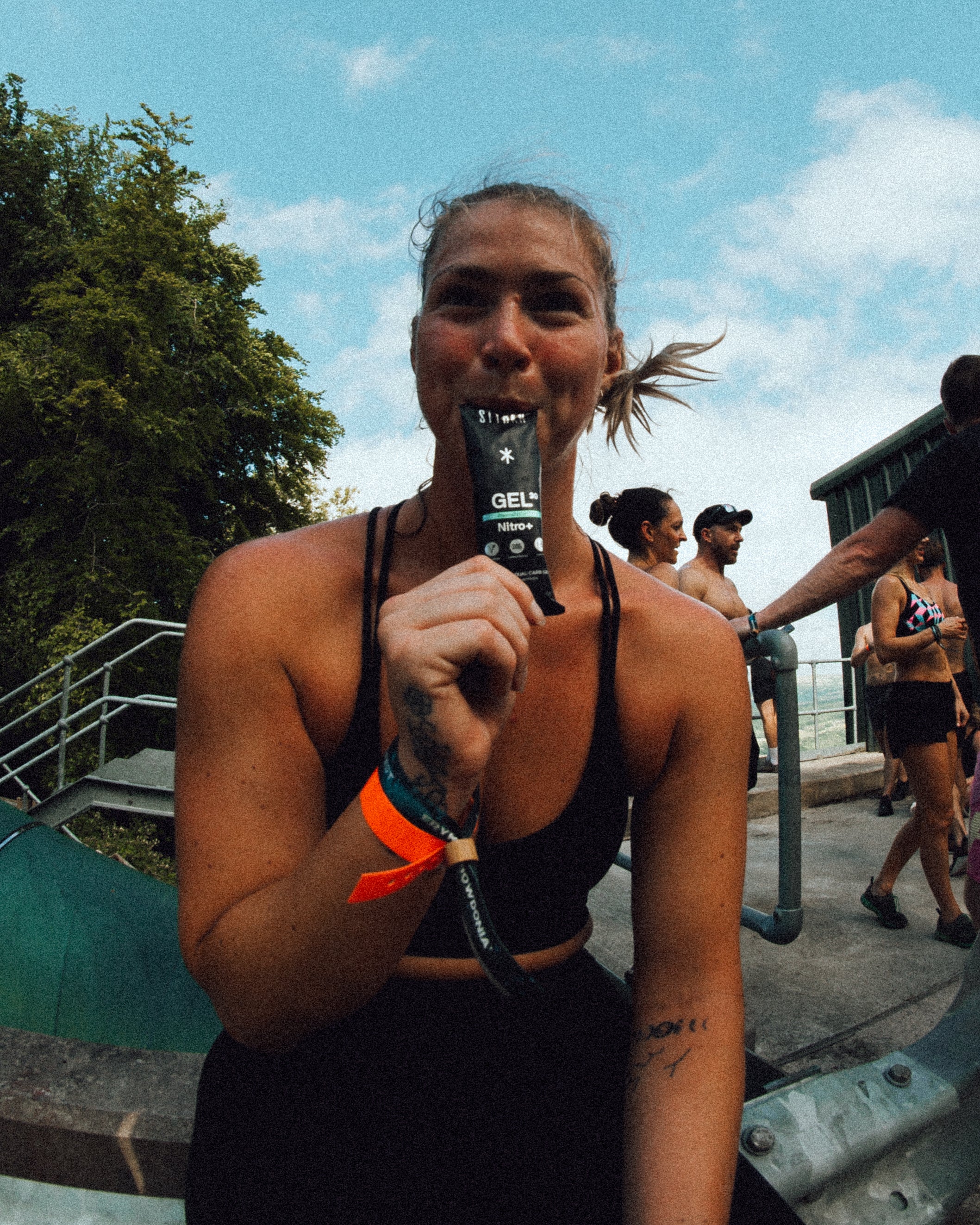 female athlete drinking styrkr energy gels