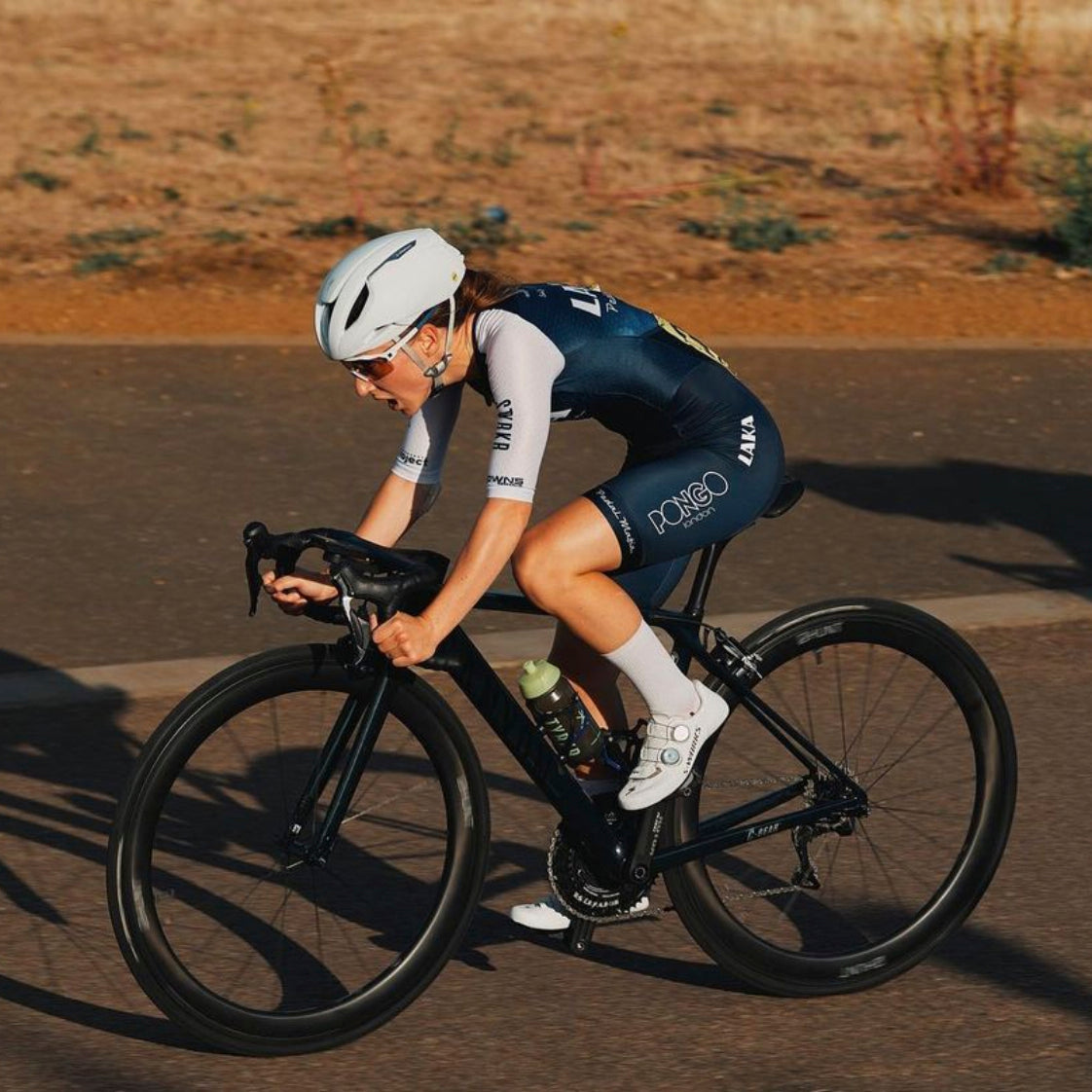 female cyclist cycling in race with full cycle gear
