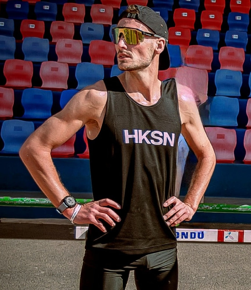 athlete thomas standing strong before a running event in a stadium 