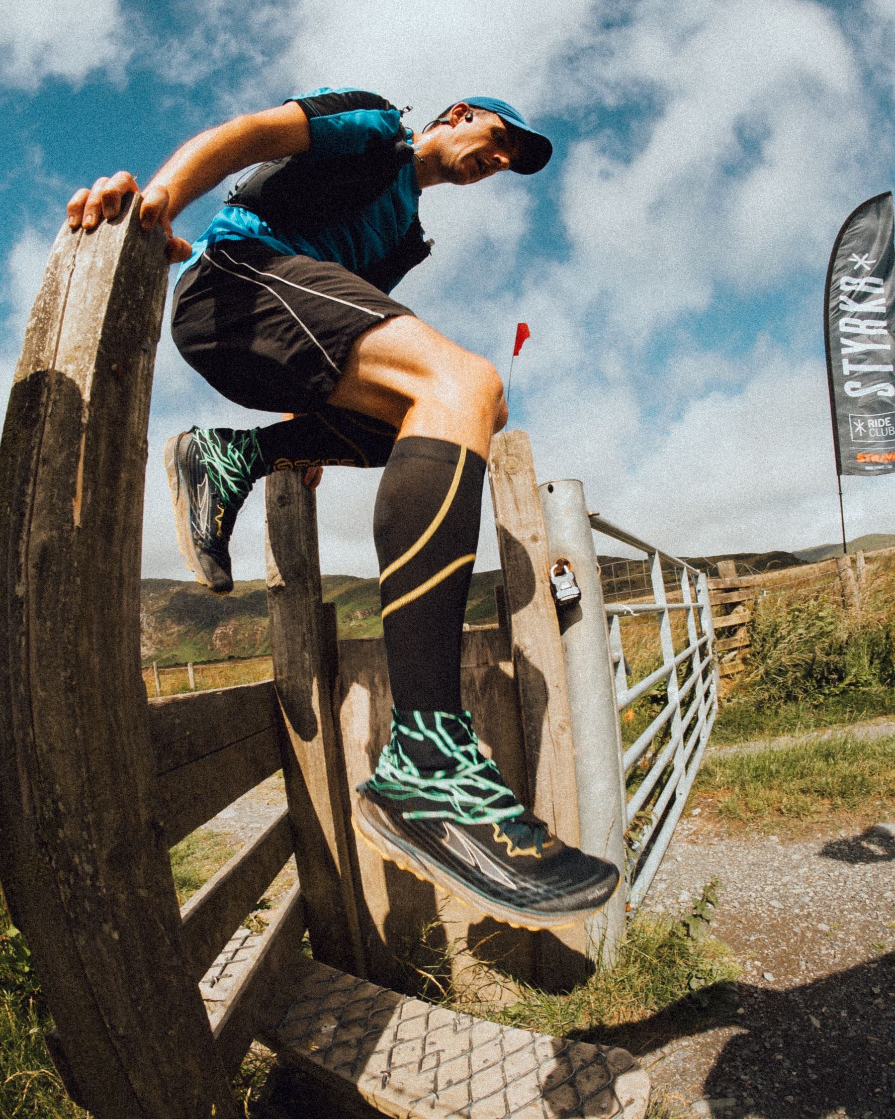 athlete jumping a hurdle on a trail run