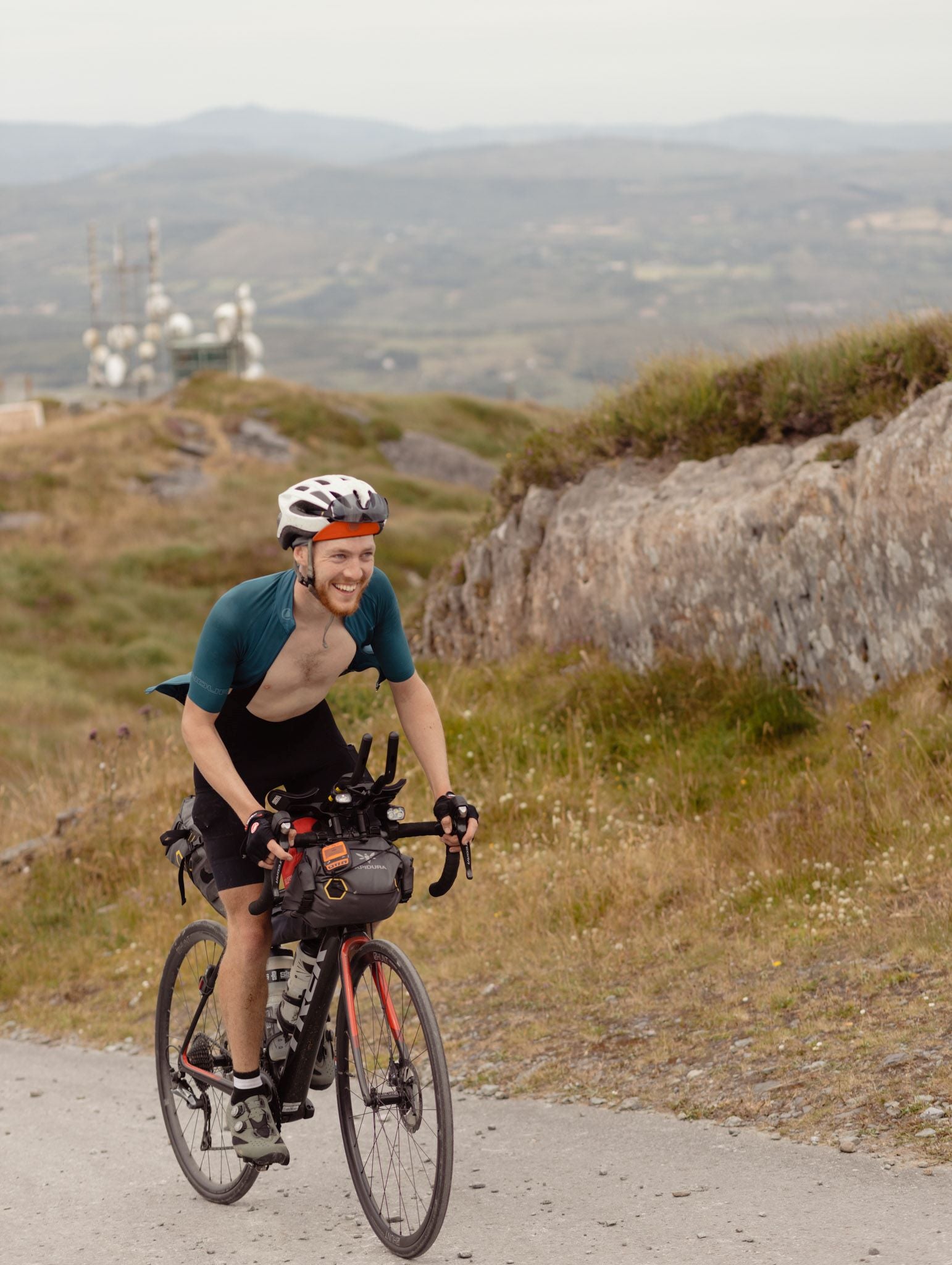 cyclist up hill looking happy he avoided hair removal for saddle sores