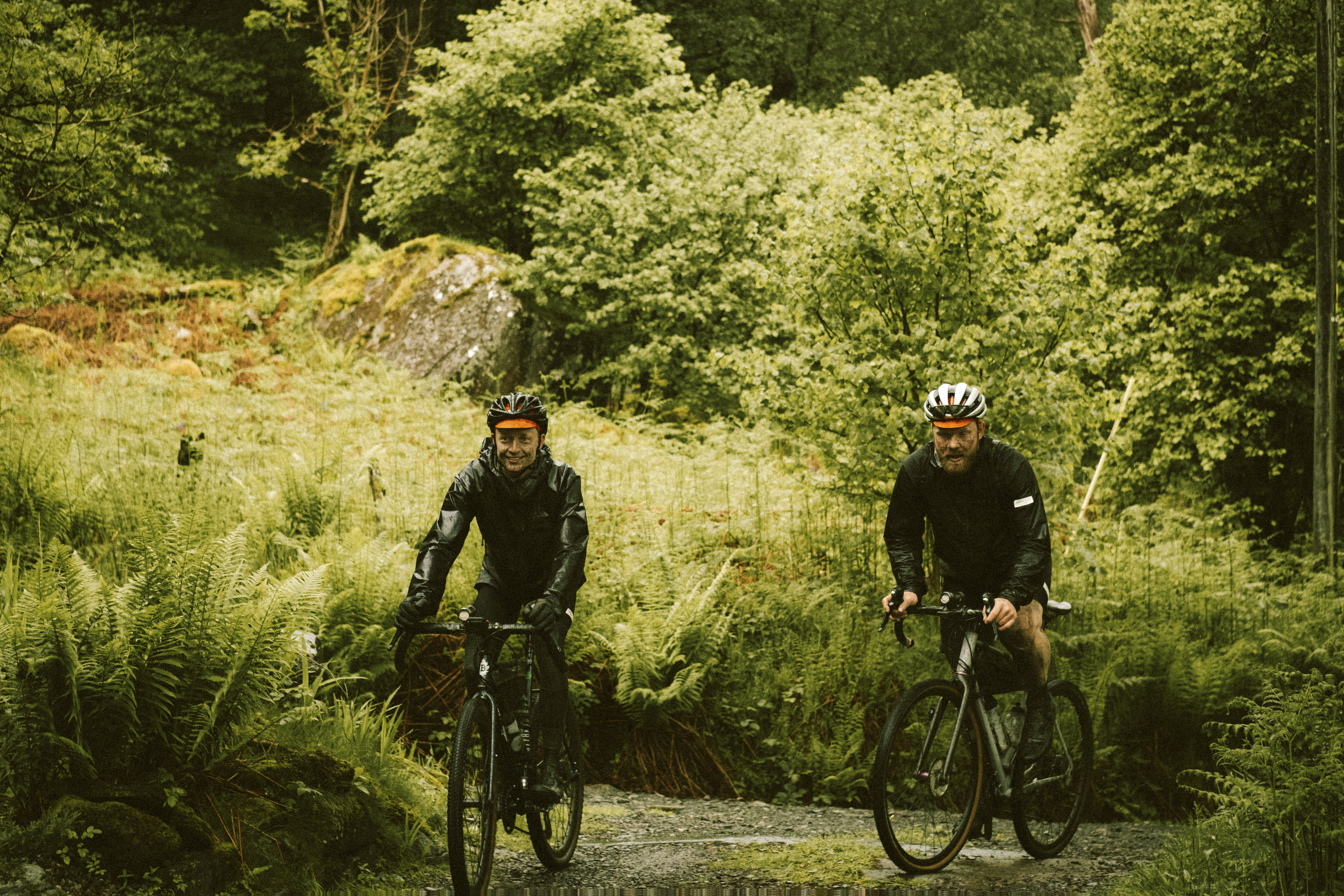 two gravel cyclists in the woods on an adventure
