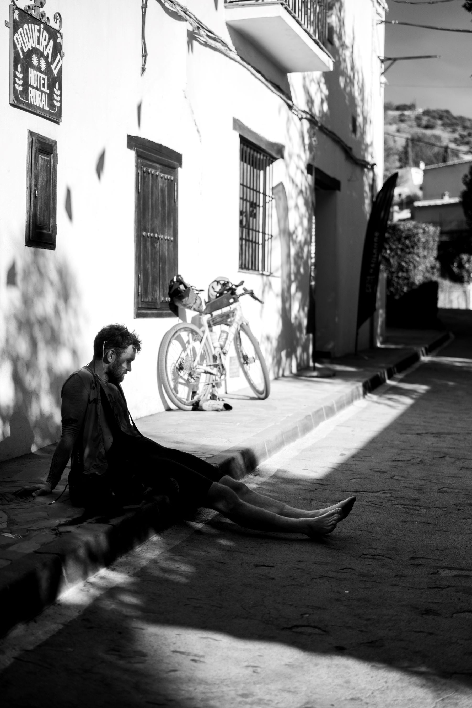 male athlete resting by his bike