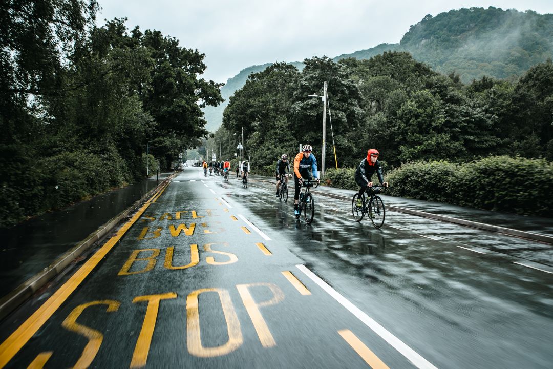 group of road cyclists in the rain