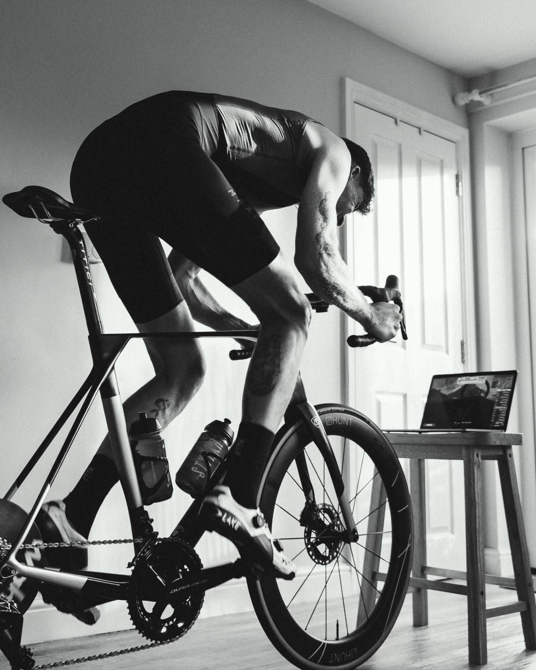 black and white image of athlete indoor cycle training