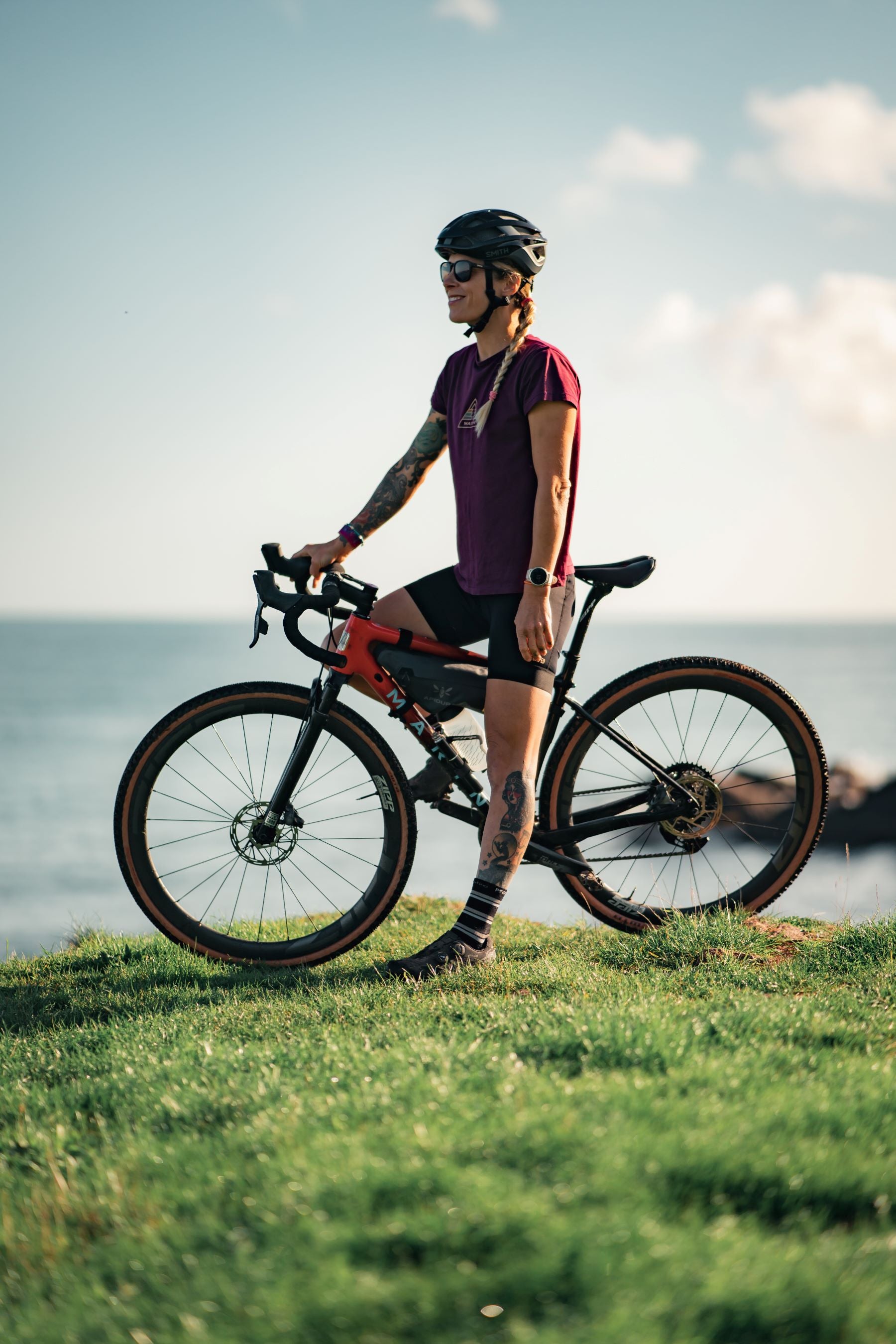 solo cyclist looking at the sea view on her cycle route