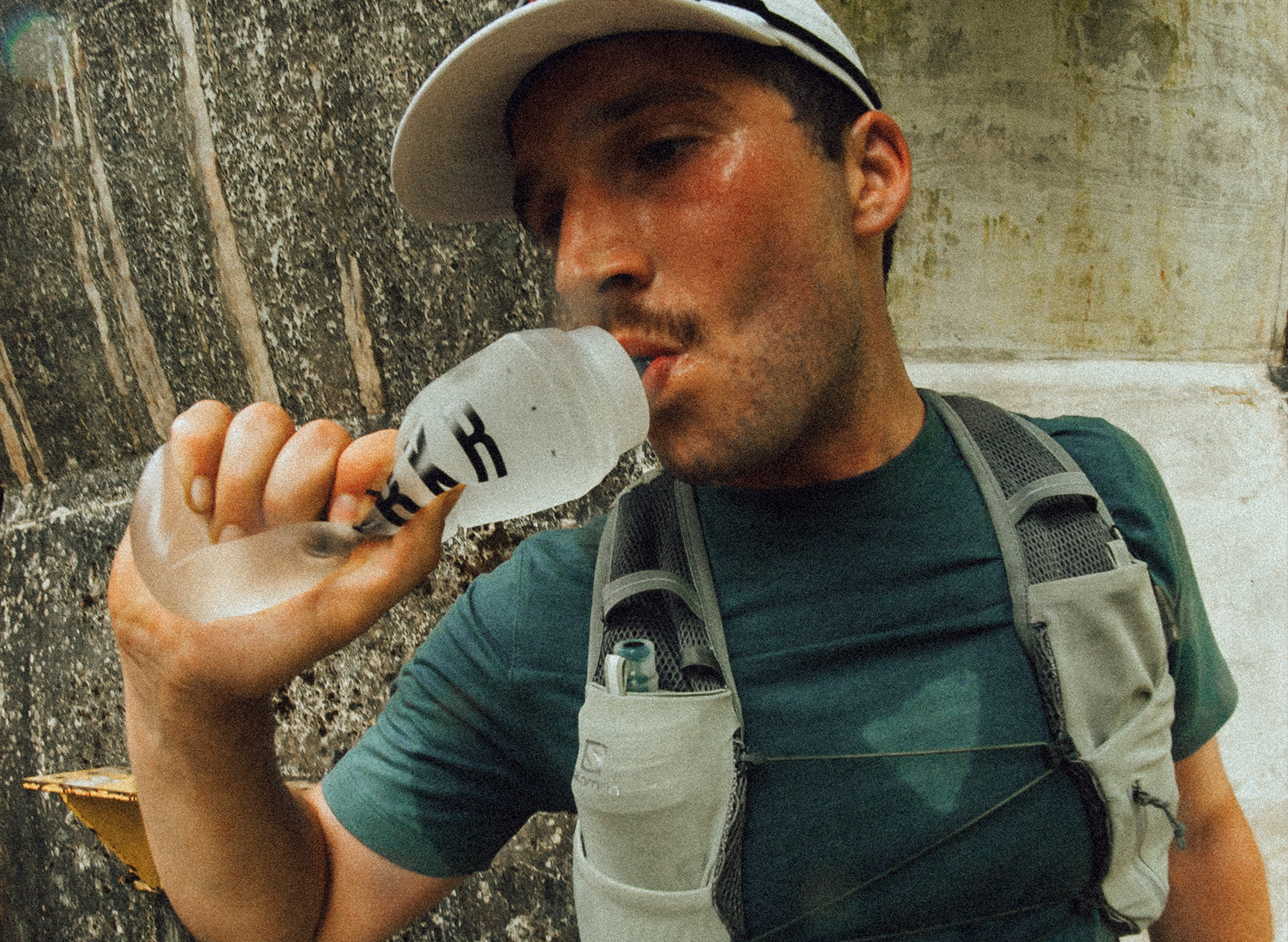 athlete hydrating on a run