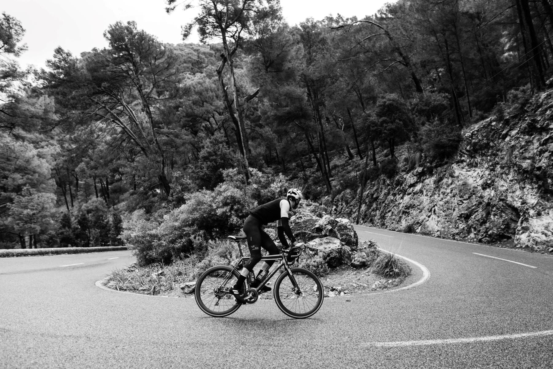 cyclist on a bike riding around a country lane roundabout