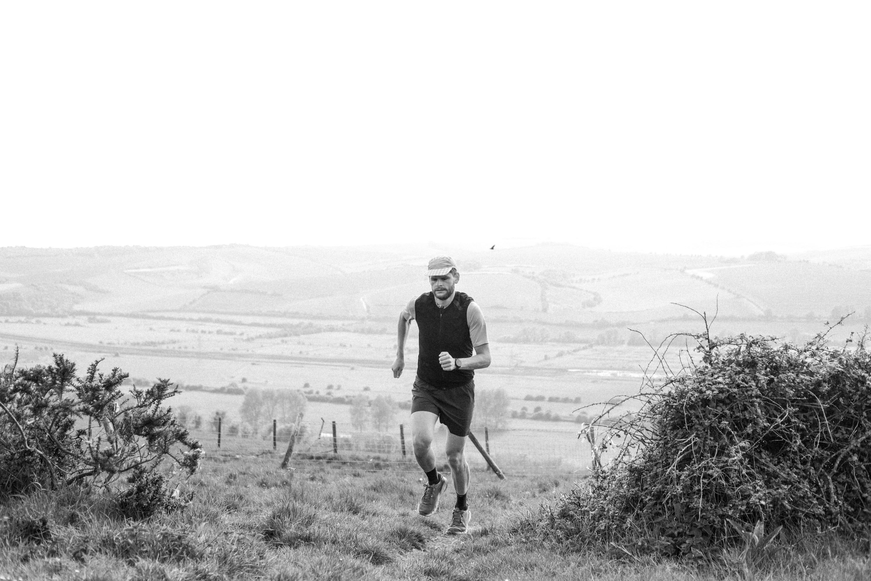 black and white image of man running and training hard