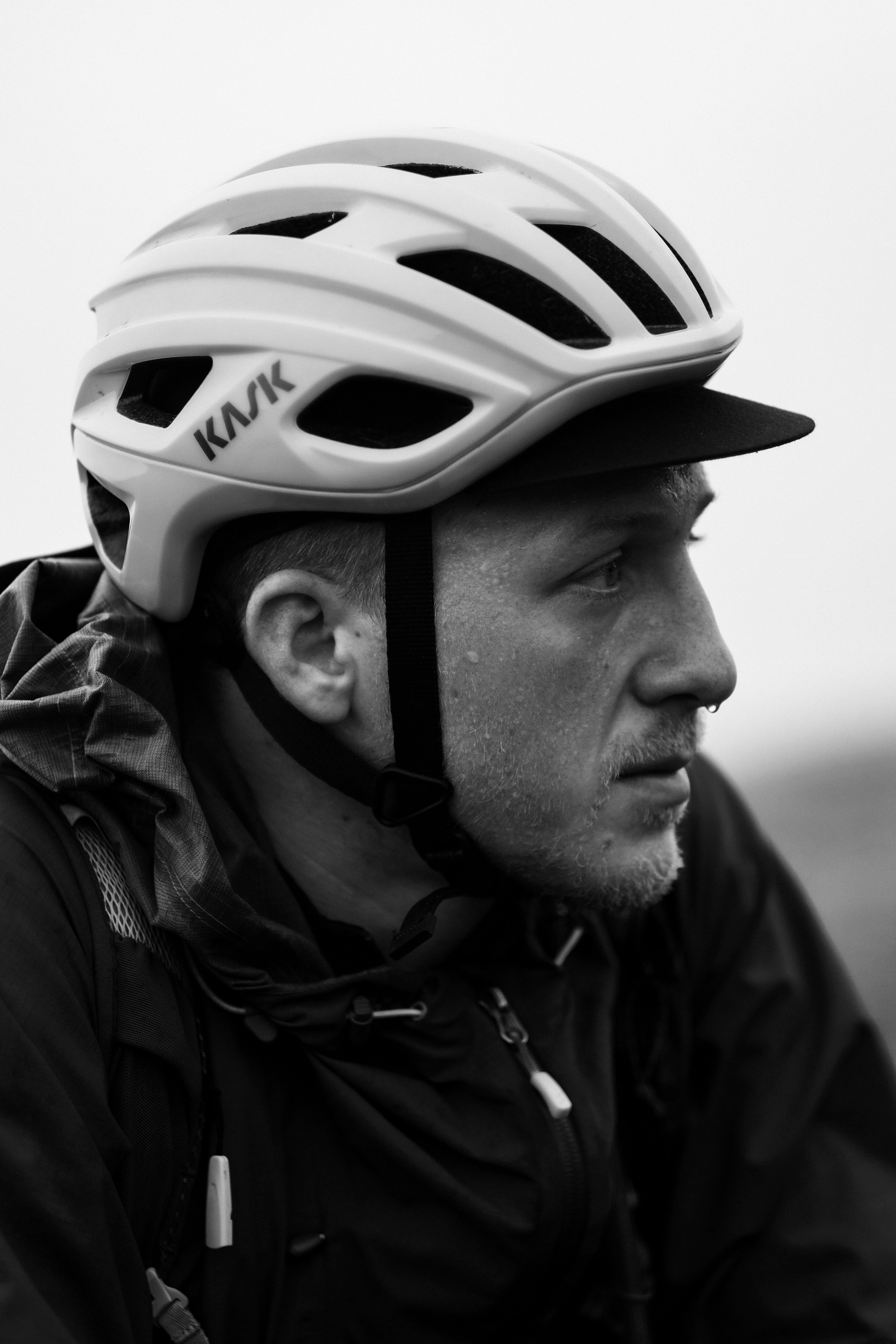 black and white close up of cyclist deep in thought ready for a race