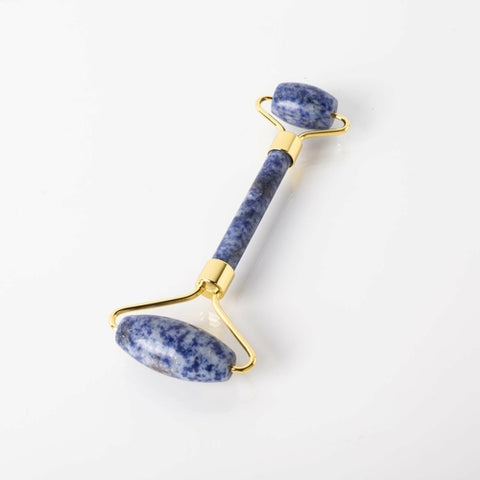 A blue soladite face roller with copper accents