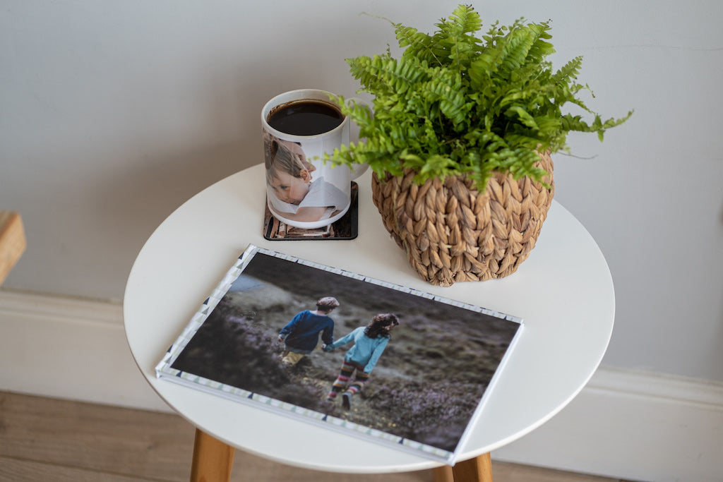 Photobook on table with mug