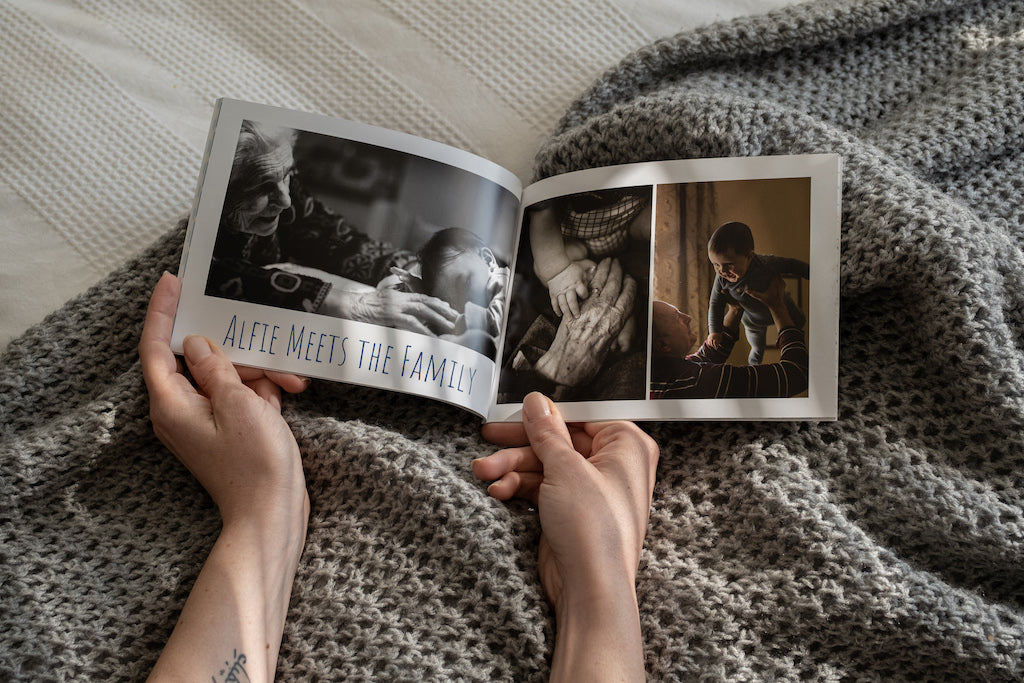 Person holding open baby photobook.