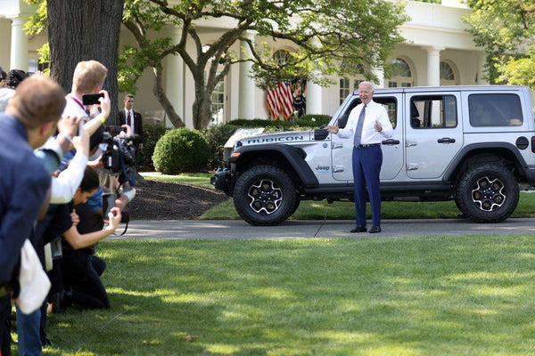 U.S. President Biden takes a group photo with the Jeep off-road vehicle