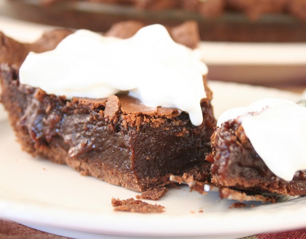 brownie pie slice topped with whipped cream