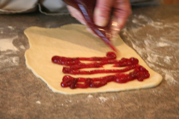 cherry filling on dough for braided bread