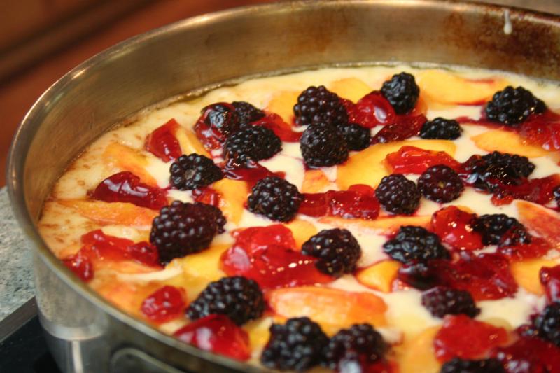 A peach berry skillet cobbler ready to go in the oven