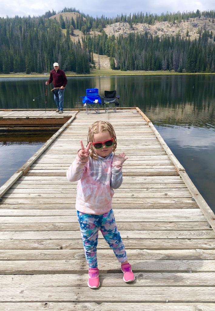 granddaughter tallying the fish she just caught with her grandfather