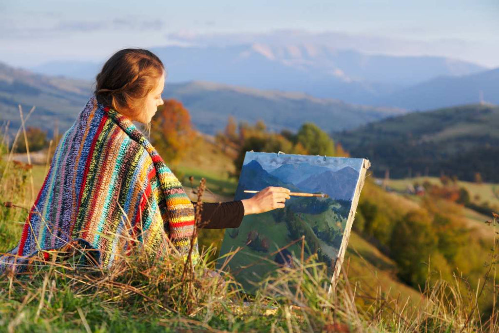 An artist in nature painting the landscape