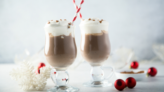 Two festive gingerbread lattes topped with whipped cream