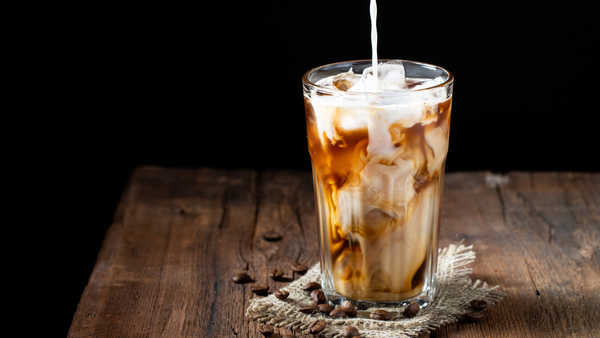 sweet vanilla cream poured over a glass of ice and cold brew