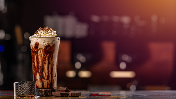 Coconut mocha frappe topped with whipped cream and a drizzle of chocolate