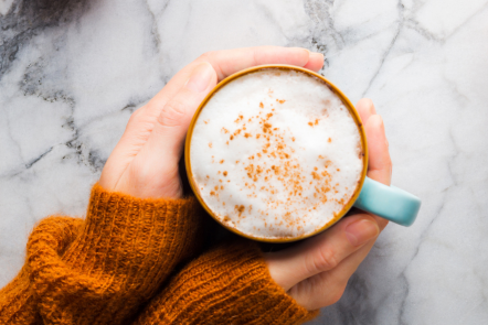 woman's hands cupping a mug of spiced orange mocha coffee