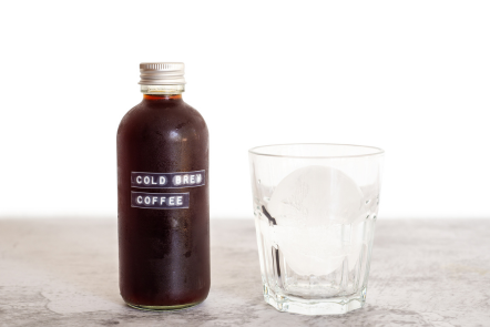 bottle of cold brew coffee next to a glass of ice