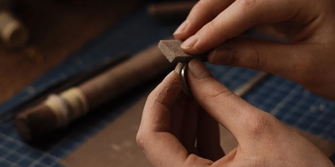 Skilled artisan polishing a 925 sterling silver.