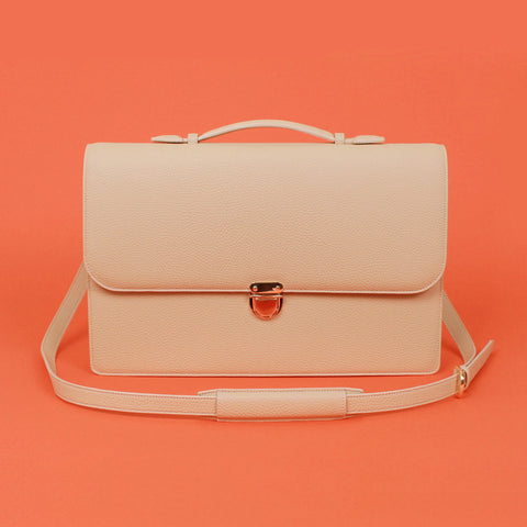 miim's novo ivory briefcase with a coral background