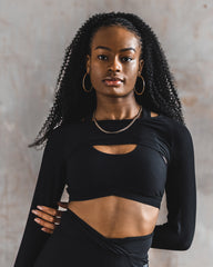 Top half of the DYNS purpose collection with black shrug and black sports bra.