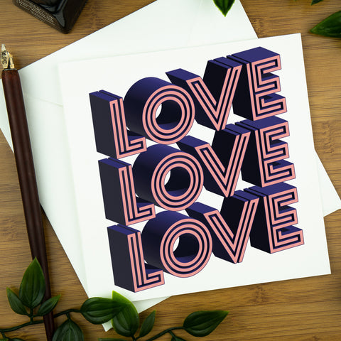 A greeting card with a 3D image of the word Love repeated here times. The colours are pink and blue.