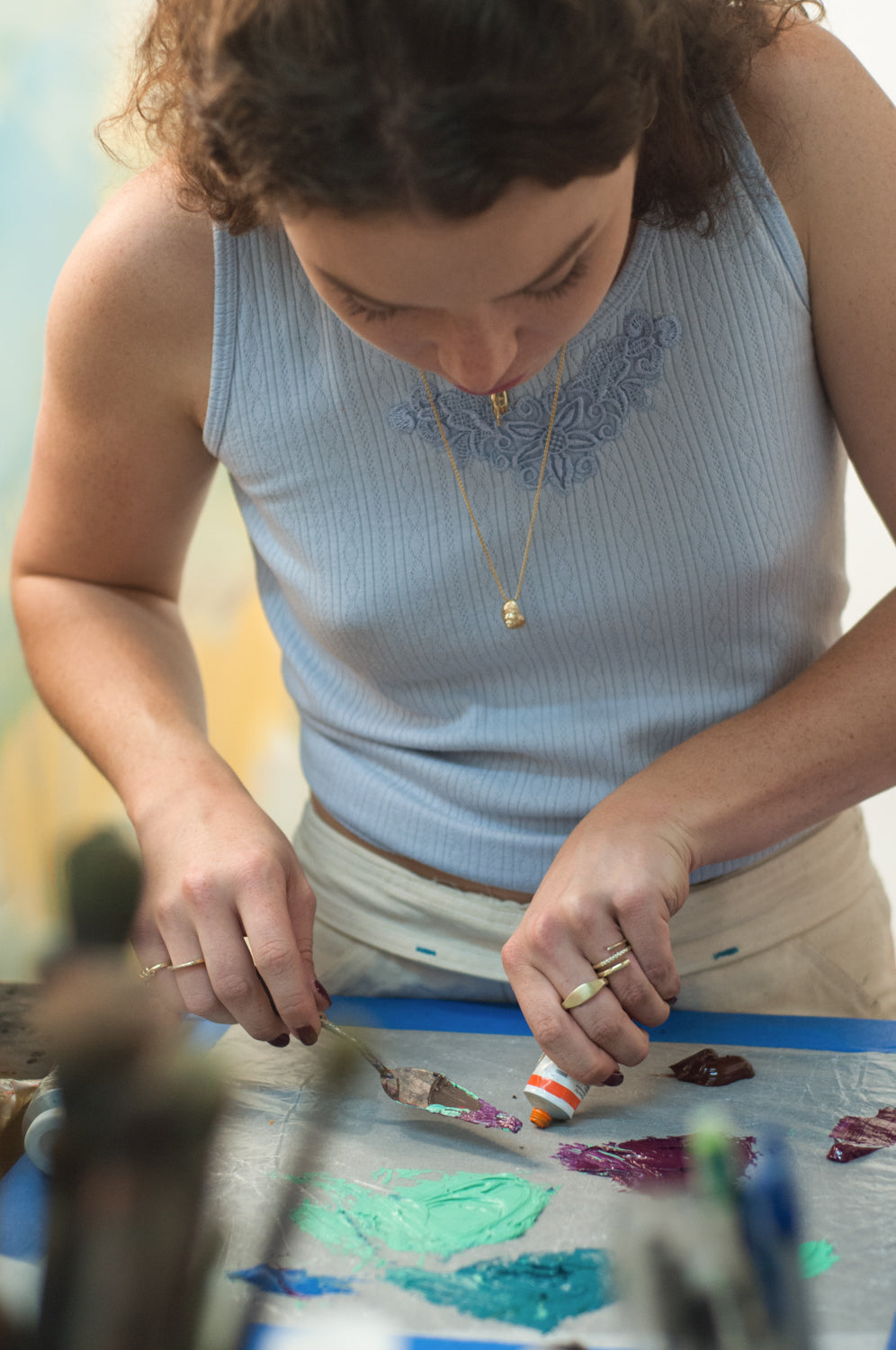 Caroline Eleanor Absher painting in her studio for Made Line Work is Love Made Visible Campaign. 