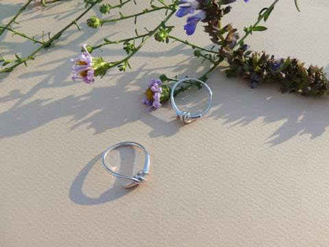 Silver knot rings with flowers and shadows