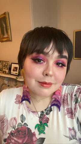 girl with pink makeup; ombre moon phase earrings changing from pink to purple