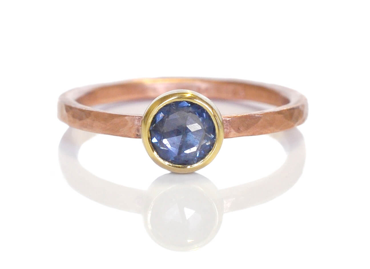 Rose cut sapphire ring on a rose gold band.