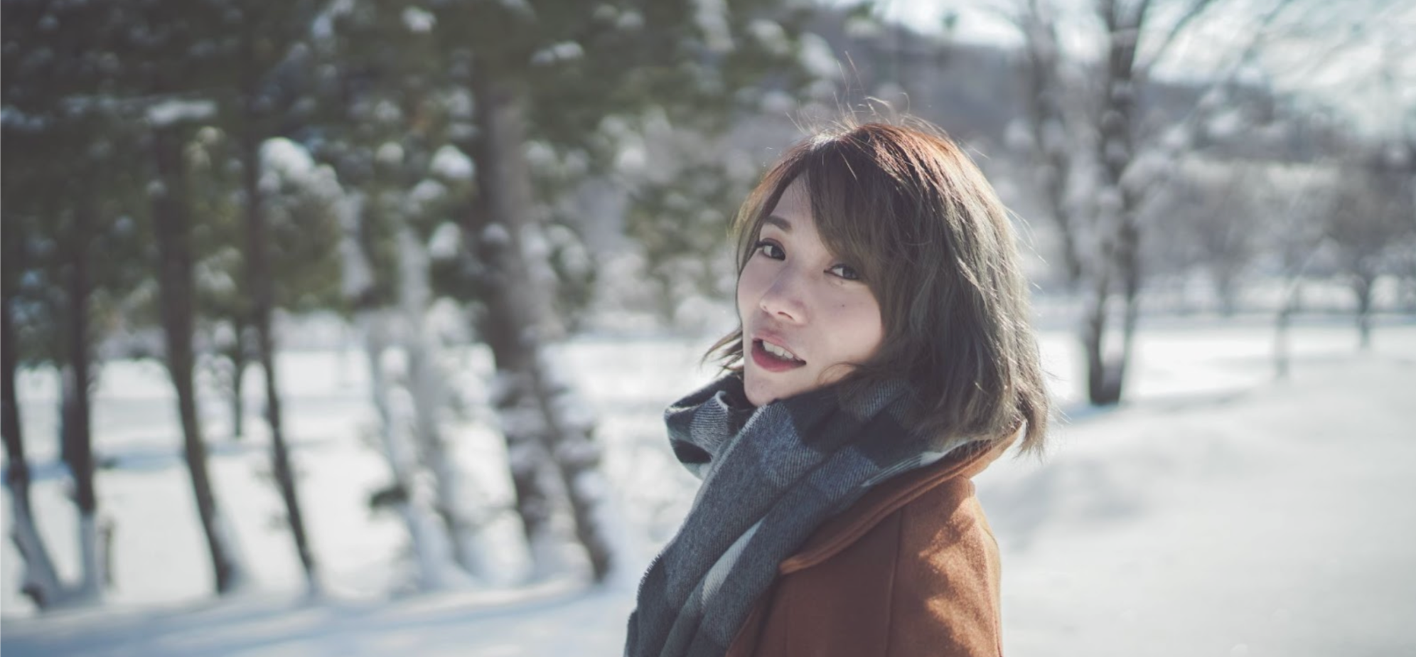 Woman wearing a scarf and coat in winter